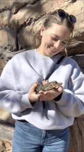 A zoo guest holding one of our baby dwarf crocodiles.