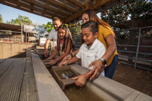 A family panning for gemstones at Two Rivers Mining Co.