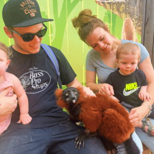 A family meeting Chili our red ruffed lemur during a private animal encounter.
